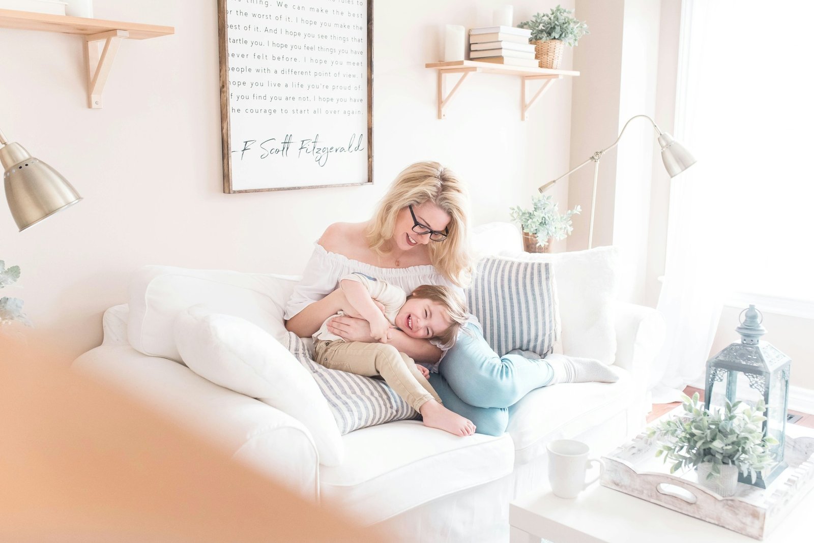 woman and child sitting on white sofa